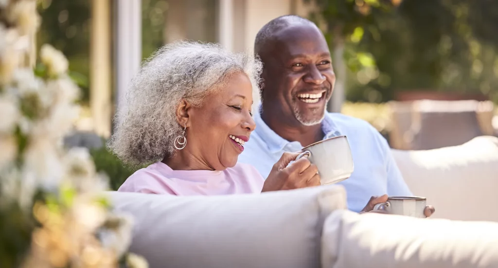 Happy elder couple outside having coffee